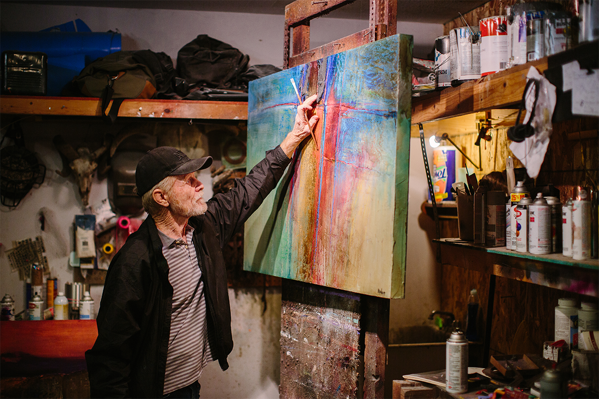 Photo of Jac Kephart painting in his studio